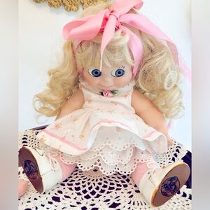 Porcelain kewpie doll blonde Blue eyes, pink, and white dress plus accessories